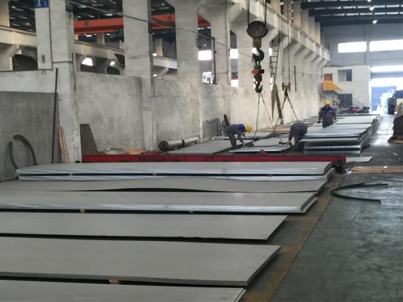 3 to 4 workers in the factory with stainless steel sheet